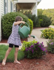 A girl watering the plants